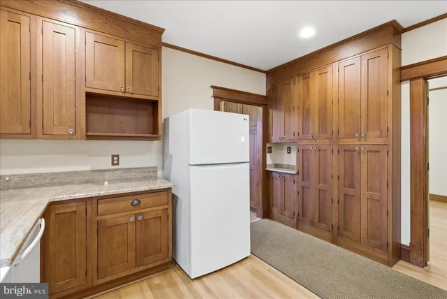a kitchen with stainless steel appliances granite countertop a refrigerator a microwave and cabinets