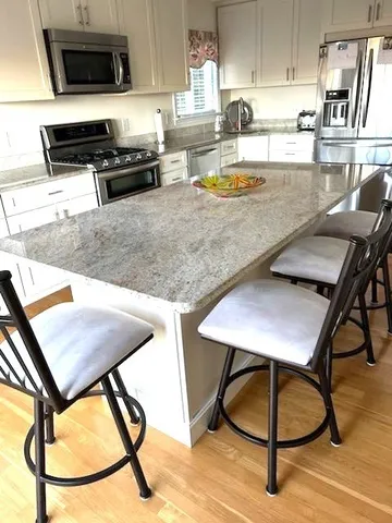 a kitchen with a table chairs and a microwave