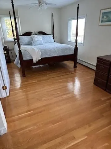 a bedroom with a bed a mirror and furniture