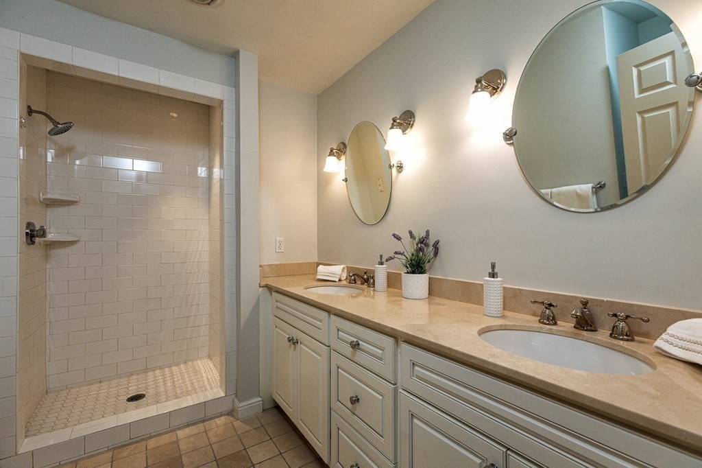 44 Eaton Road Lexington, MA 02420 - Photo 16 of 24 a bathroom with a double vanity sink mirror and shower