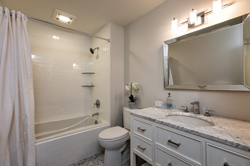 44 Eaton Road Lexington, MA 02420 - Photo 19 of 24 a bathroom with a granite countertop toilet a sink and a mirror