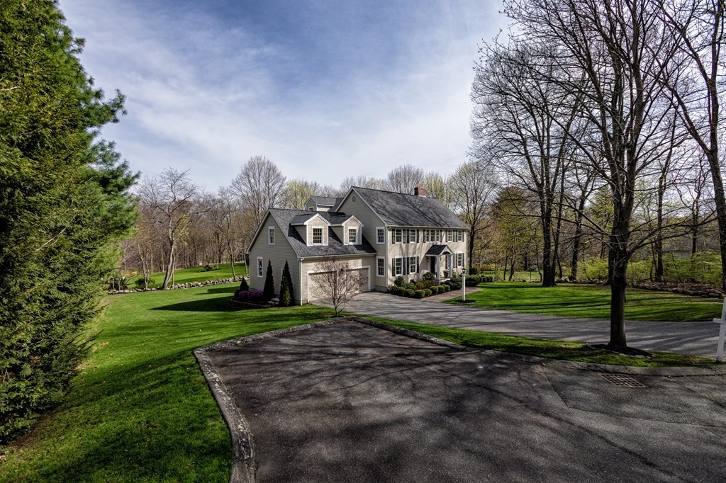 44 Eaton Road Lexington, MA 02420 - Photo 2 of 24 a front view of a house with a yard table and chairs