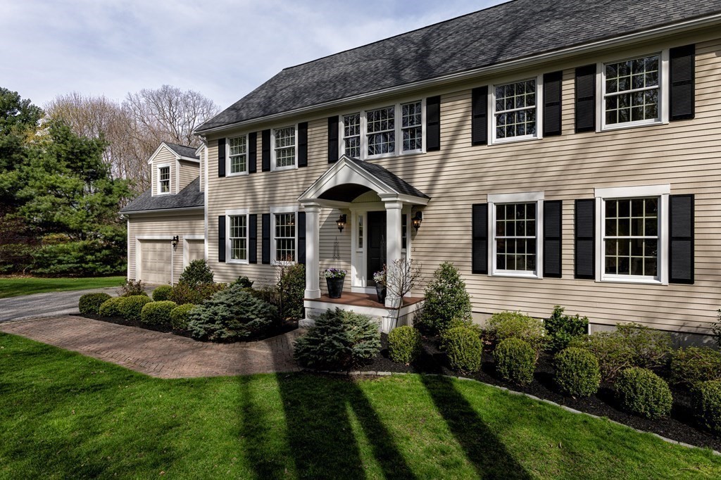 44 Eaton Road Lexington, MA 02420 - Photo 3 of 24 a front view of a house with a yard and potted plants