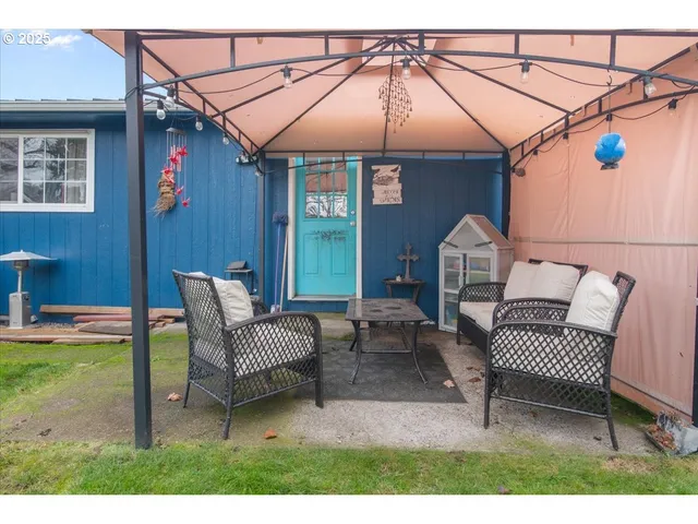 a view of a house with a yard and sitting area