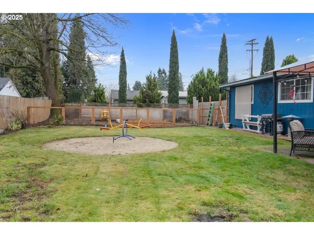 a backyard of a house with table and chairs