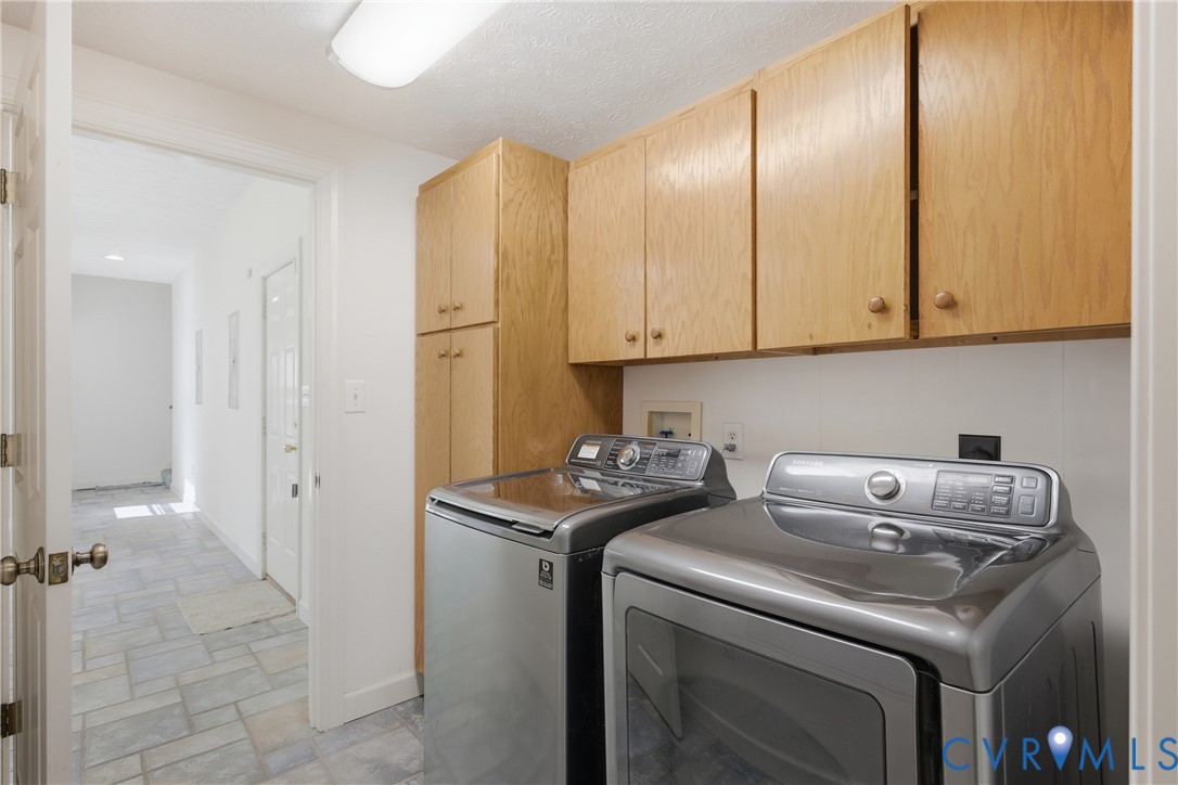 13265 Coulbourn Road Saluda, VA 23149 - Photo 15 of 62 a view of a storage and utility room with washer and dryer