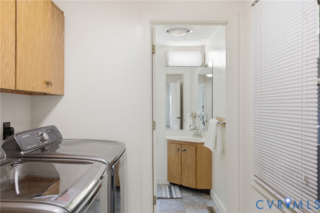 13265 Coulbourn Road Saluda, VA 23149 - Photo 16 of 62 a utility room with a sink dryer and washer
