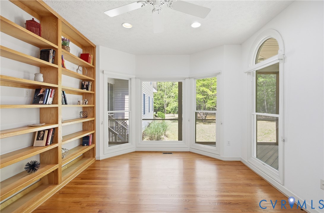 13265 Coulbourn Road Saluda, VA 23149 - Photo 19 of 62 a view of an empty room with a window and wooden floor