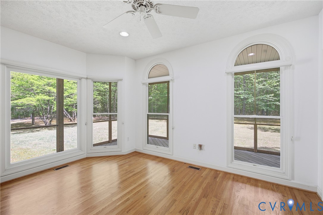 13265 Coulbourn Road Saluda, VA 23149 - Photo 21 of 62 a view of an empty room with a window and wooden floor