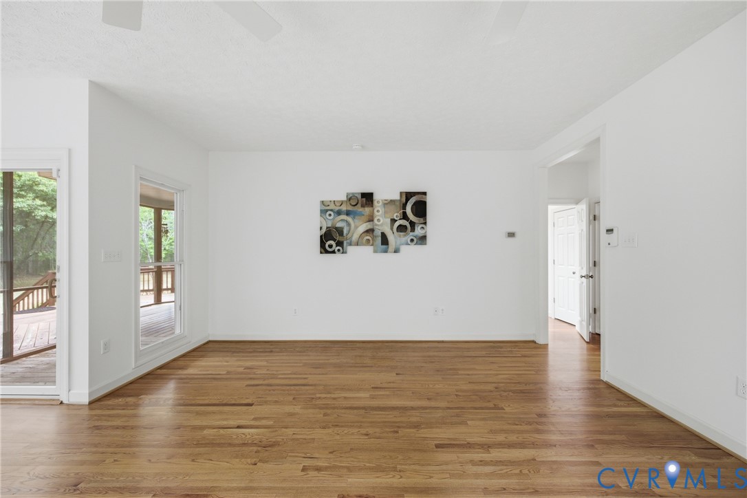 13265 Coulbourn Road Saluda, VA 23149 - Photo 23 of 62 a view of an empty room with wooden floor and a window