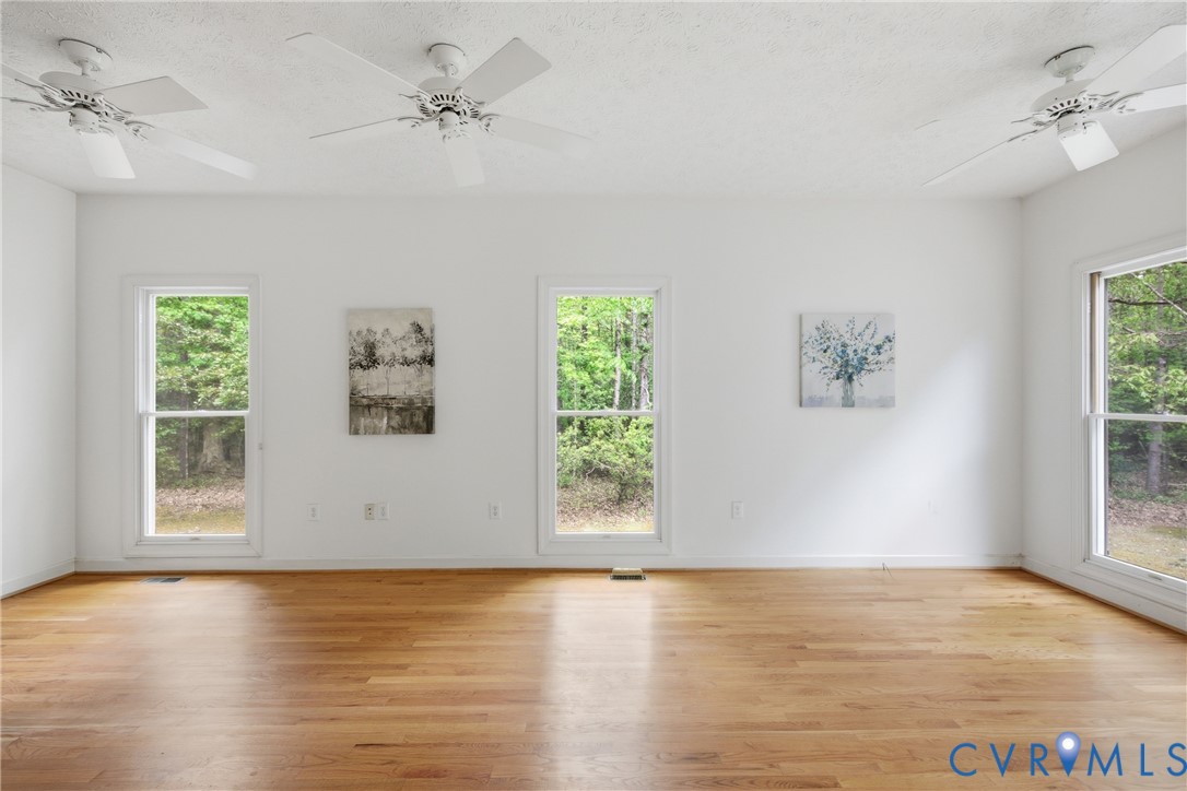 13265 Coulbourn Road Saluda, VA 23149 - Photo 24 of 62 a view of an empty room with wooden floor and a window