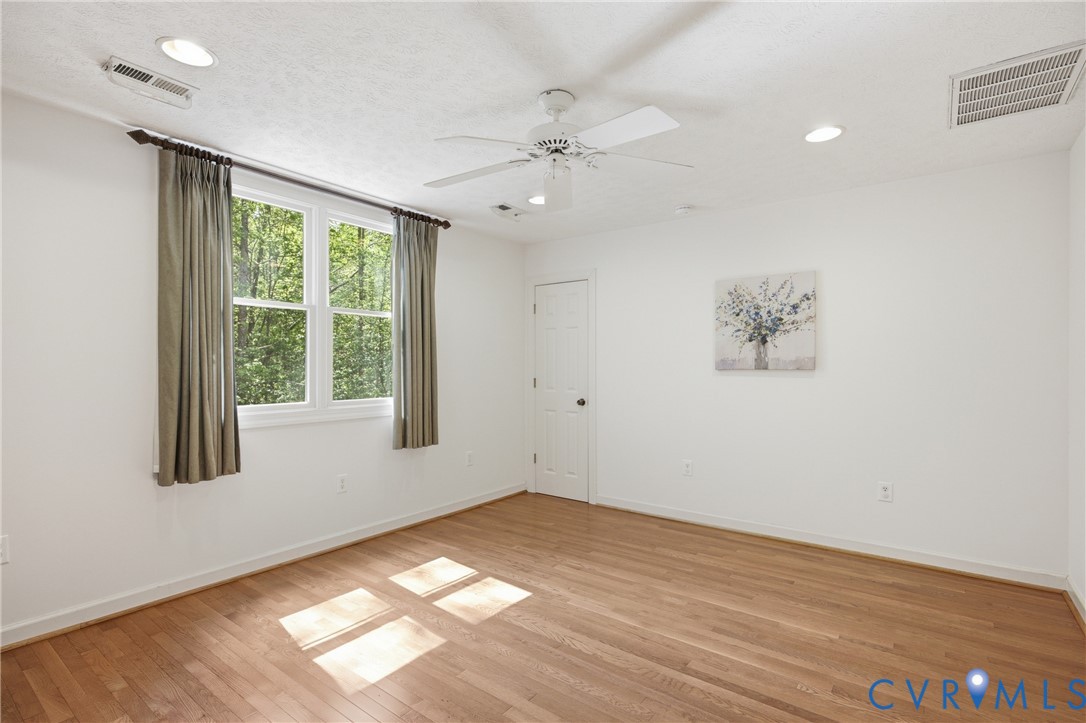 13265 Coulbourn Road Saluda, VA 23149 - Photo 31 of 62 wooden floor in an empty room with a window