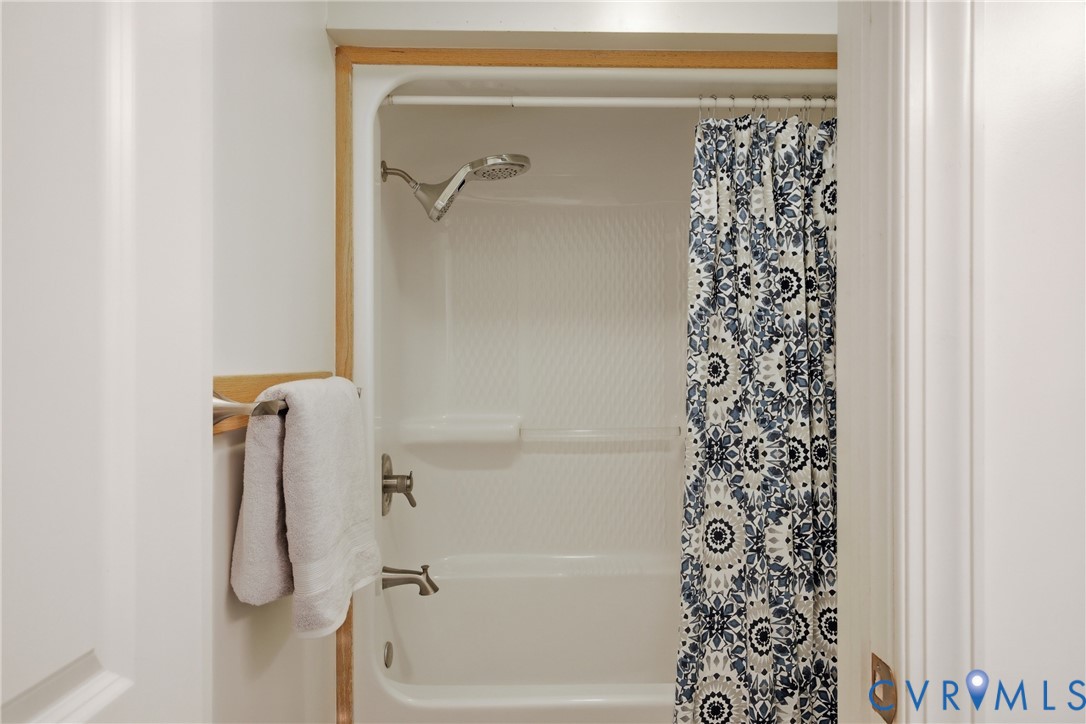 13265 Coulbourn Road Saluda, VA 23149 - Photo 37 of 62 White shower-over-tub combination with textured wa