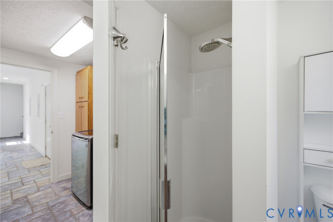 13265 Coulbourn Road Saluda, VA 23149 - Photo 39 of 62 a bathroom with a glass shower door and a glass door