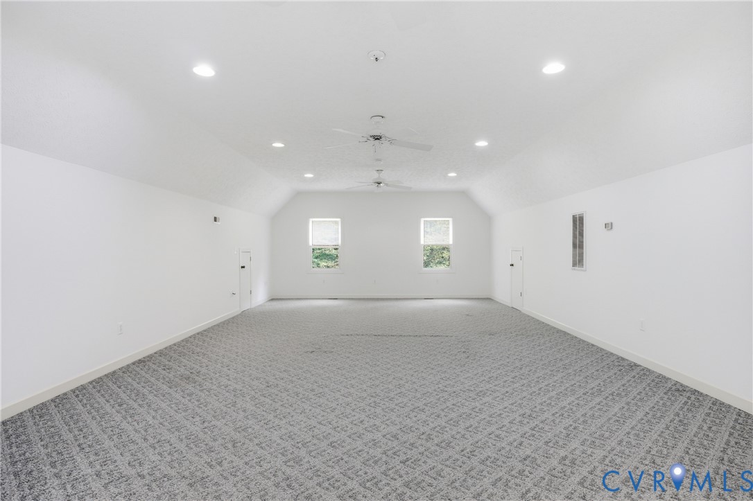 13265 Coulbourn Road Saluda, VA 23149 - Photo 41 of 62 Expansive room featuring vaulted ceilings, pattern