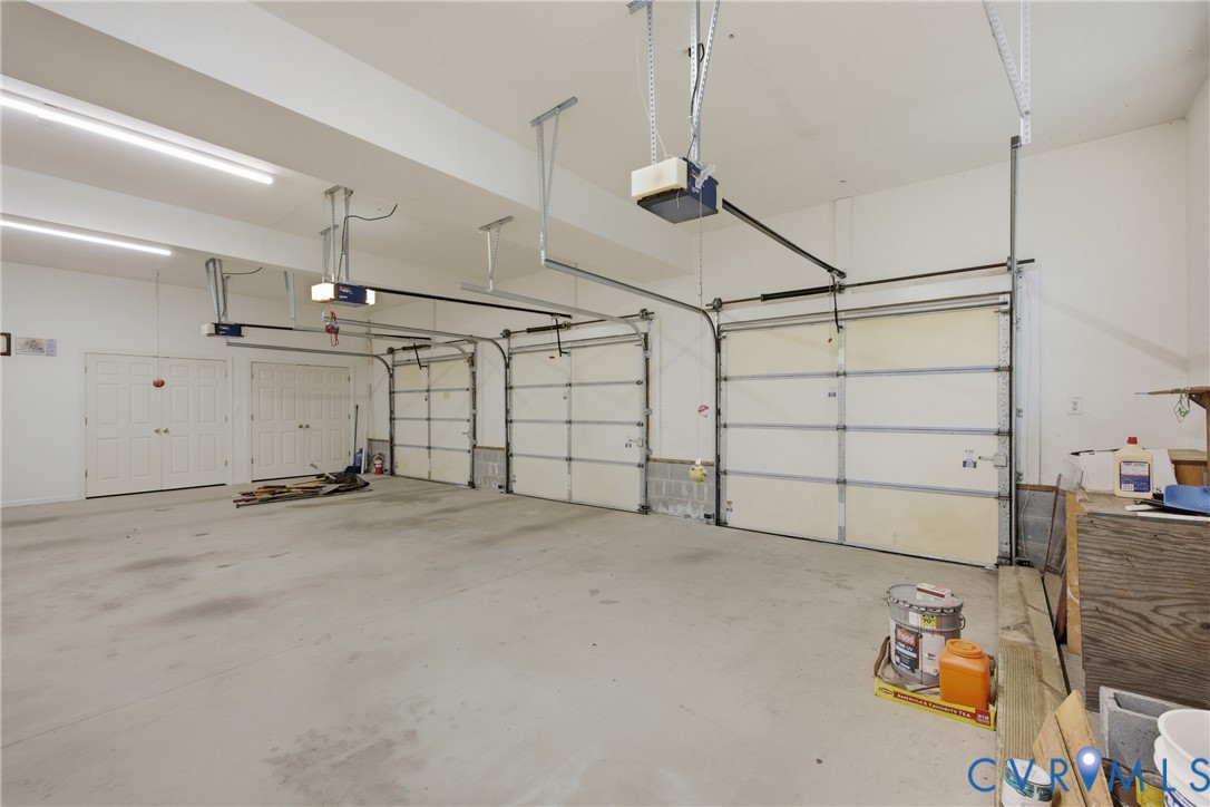 13265 Coulbourn Road Saluda, VA 23149 - Photo 43 of 62 Spacious three-car garage featuring a concrete flo