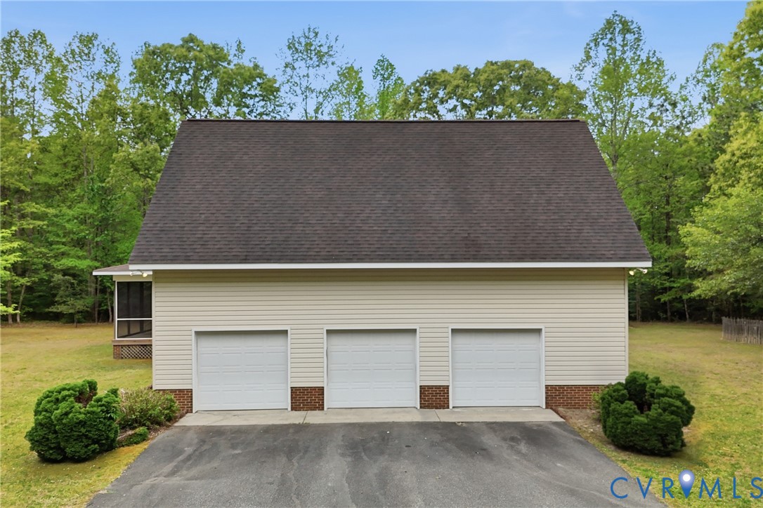 13265 Coulbourn Road Saluda, VA 23149 - Photo 47 of 62 Three-car garage with white paneled doors, light-c
