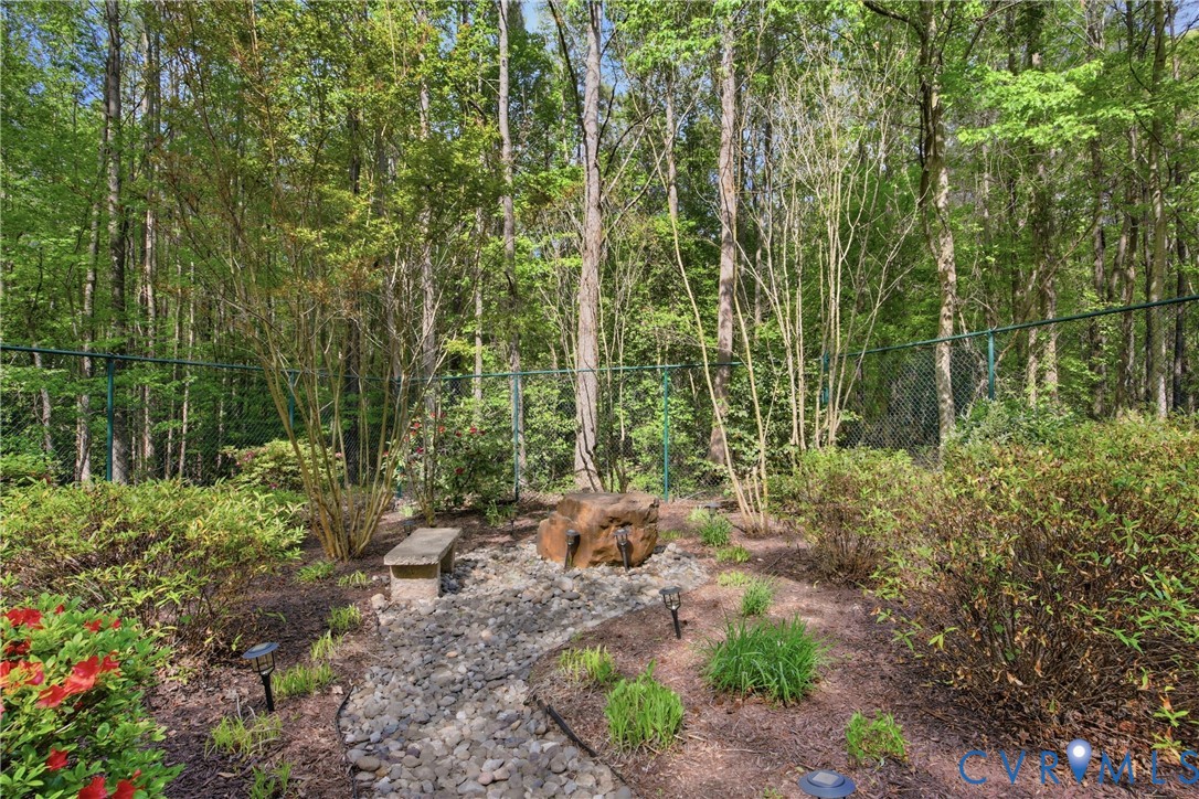 13265 Coulbourn Road Saluda, VA 23149 - Photo 55 of 62 Wooded backyard with decorative landscaping, a sto