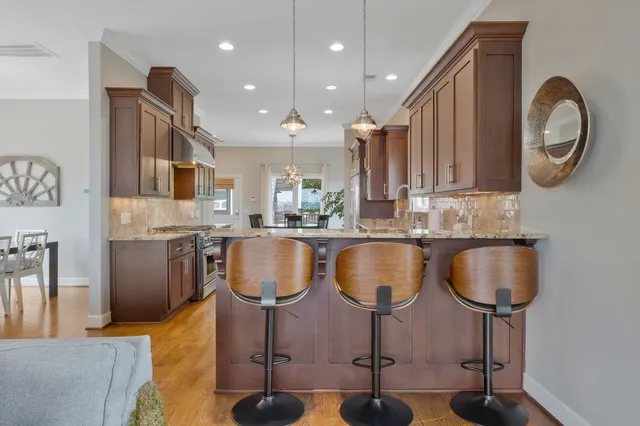 a kitchen with stainless steel appliances granite countertop wooden cabinets a sink and dishwasher