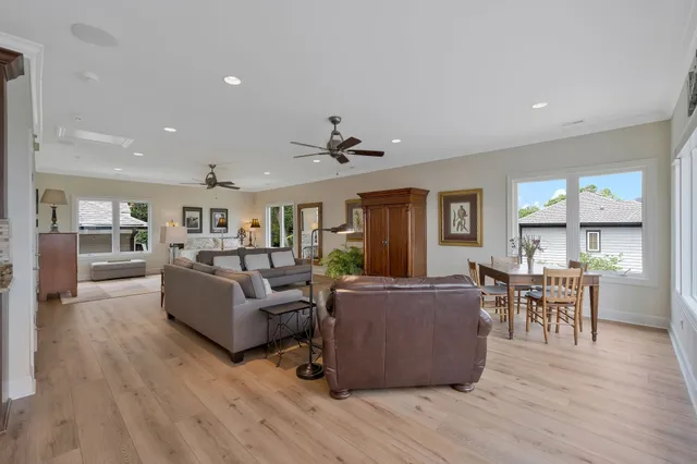a view of a patio with table and chairs potted plants with wooden floor and fence