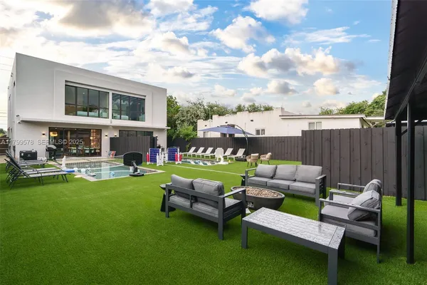a view of a patio with couches chairs and a fire pit