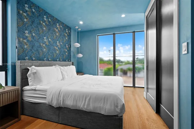 a bedroom with a large bed and a large window