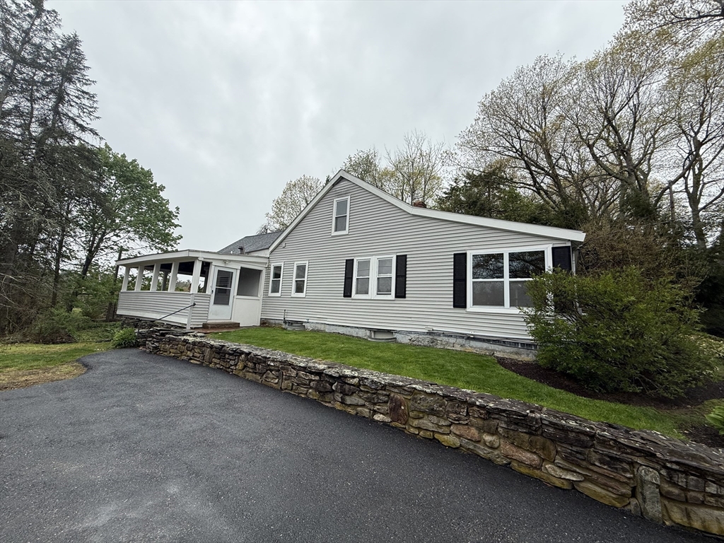84 Emerald Road, Unit 1 Rutland, MA 01543 - Photo 22 of 22 a view of a house with a yard and a large tree