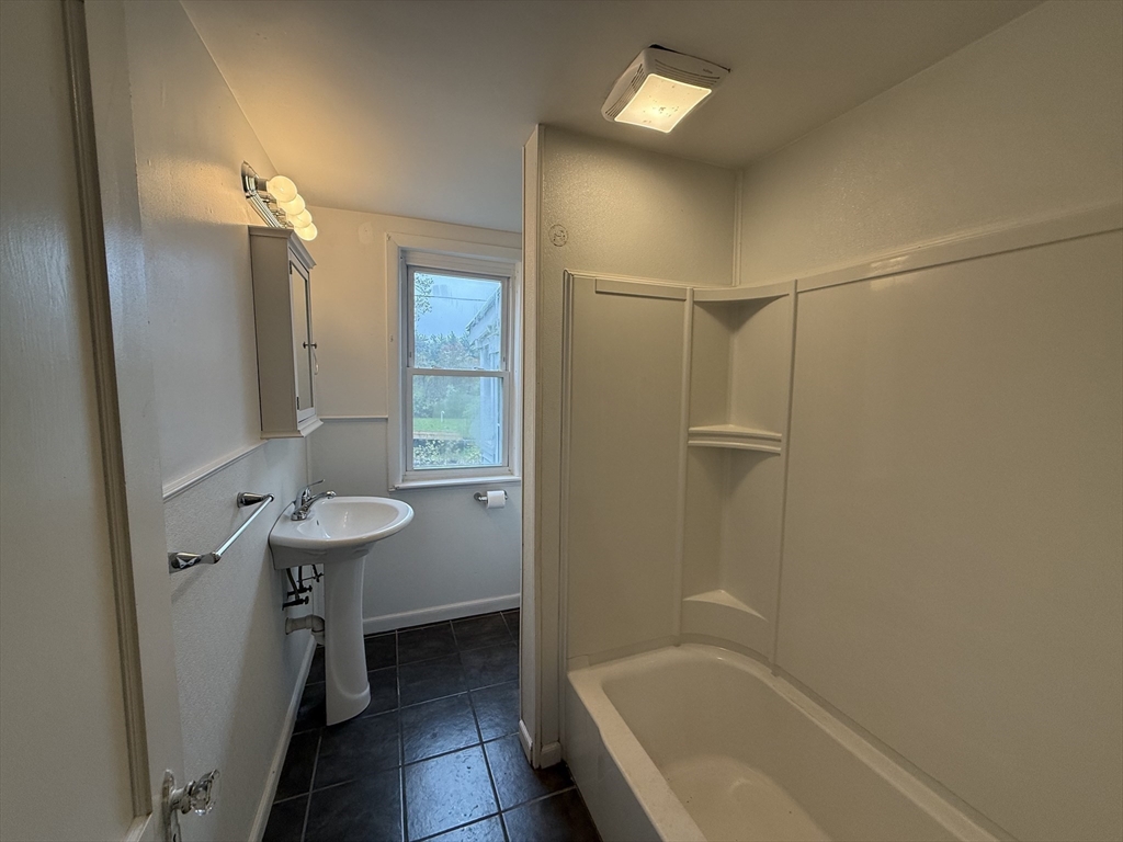 84 Emerald Road, Unit 1 Rutland, MA 01543 - Photo 7 of 22 a bathroom with a sink a toilet and shower