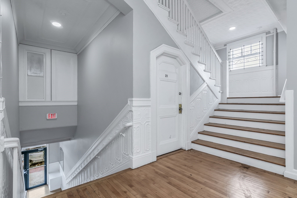 202 Broadway, Unit 23 Lawrence, MA 01840 - Photo 13 of 15 a view of entryway with stairs and wooden floor