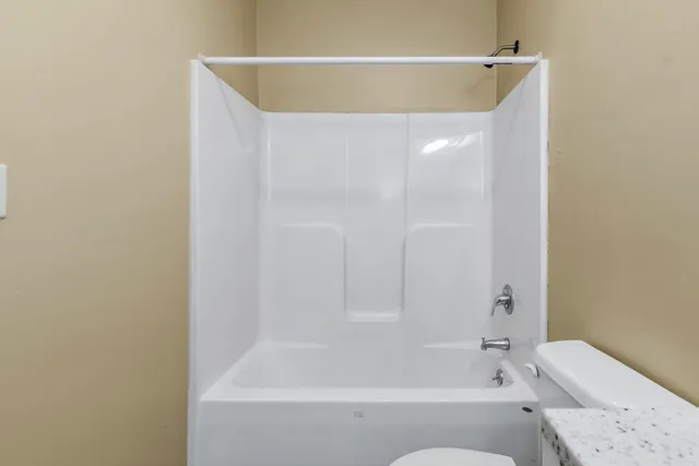 a bathroom with a bathtub and a toilet