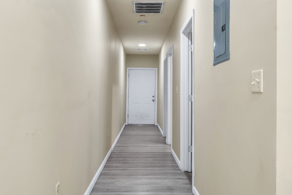 202 Broadway, Unit 23 Lawrence, MA 01840 - Photo 6 of 15 a view of a hallway with wooden floor