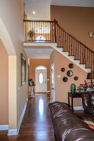 a living room with furniture and a wooden floor