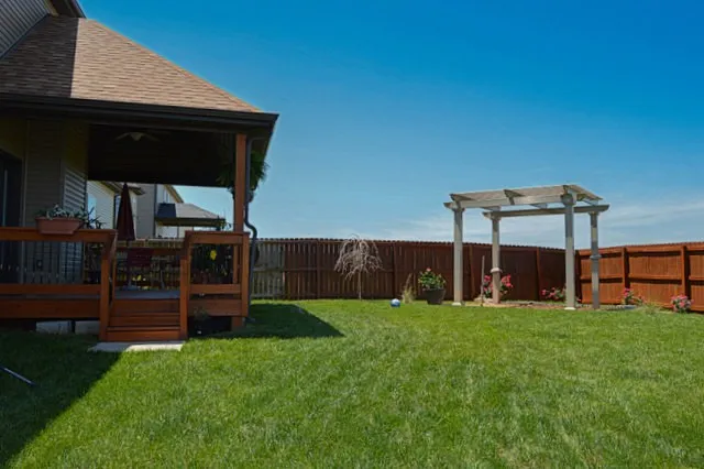 a view of a chairs and table in patio with potted plants