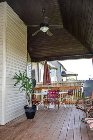 a view of a backyard with wooden fence