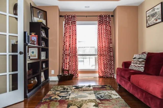 a living room with furniture and a book shelf