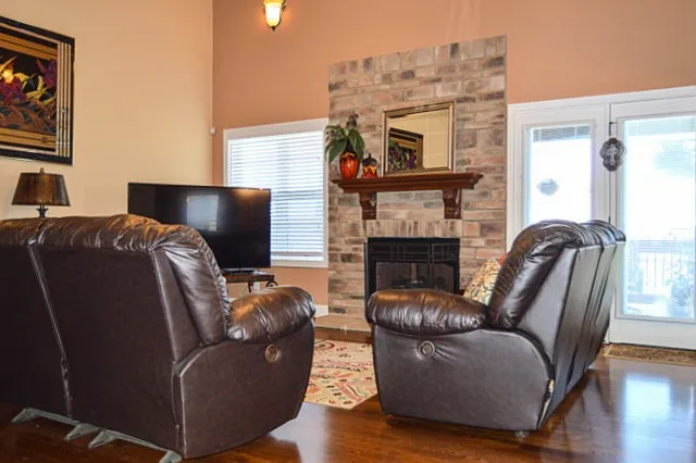 a living room with furniture a fireplace and a flat screen tv