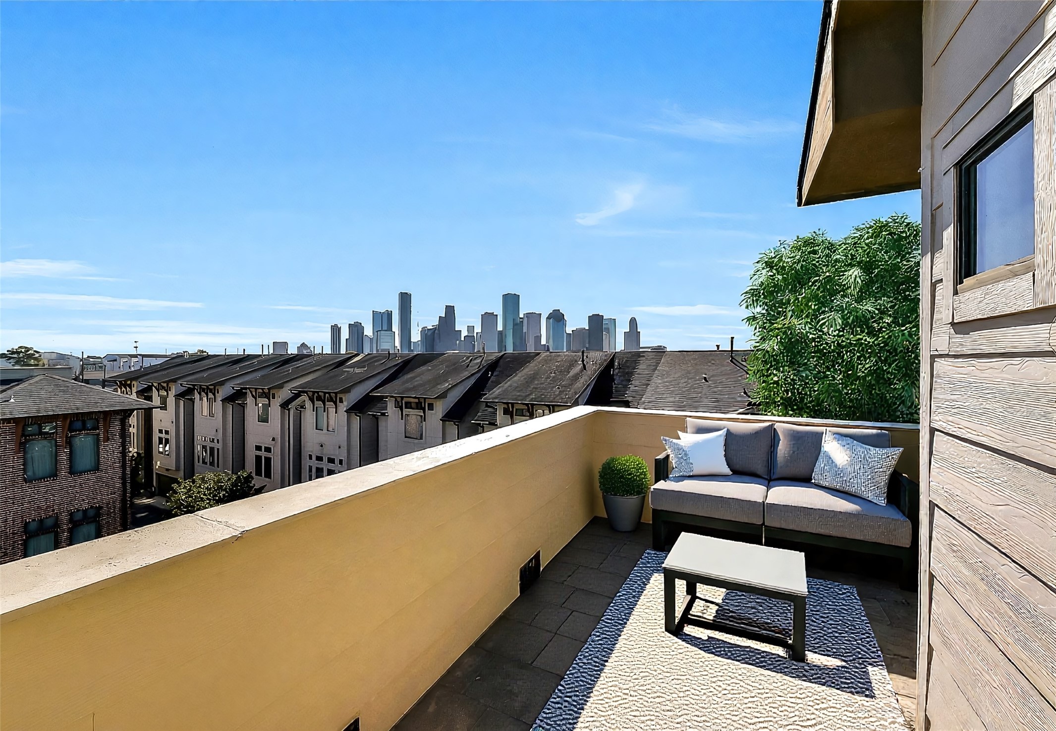 1929 Summer Street Houston, TX 77007 - Photo 23 of 27 Fabulous expansive wrap-around rooftop terrace with an unbeatable unobstructed Downtown skyline view plus views of the resort-style pool below. Imagine watching 4th of July fireworks from your very own rooftop terrace with this to-die-for view! Plenty of room for outdoor furniture—ideal for entertaining or relaxing year-round. Note: The furniture in this photo is virtually staged.