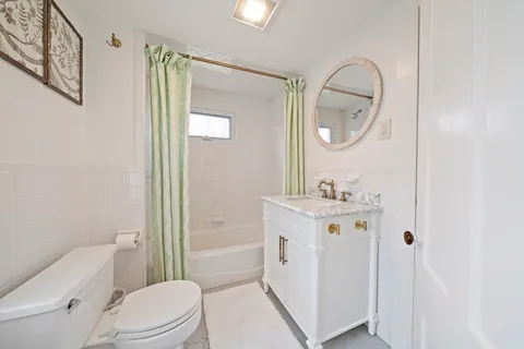 a bathroom with a sink a mirror a toilet and a shower