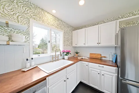 a kitchen with white cabinets and a sink