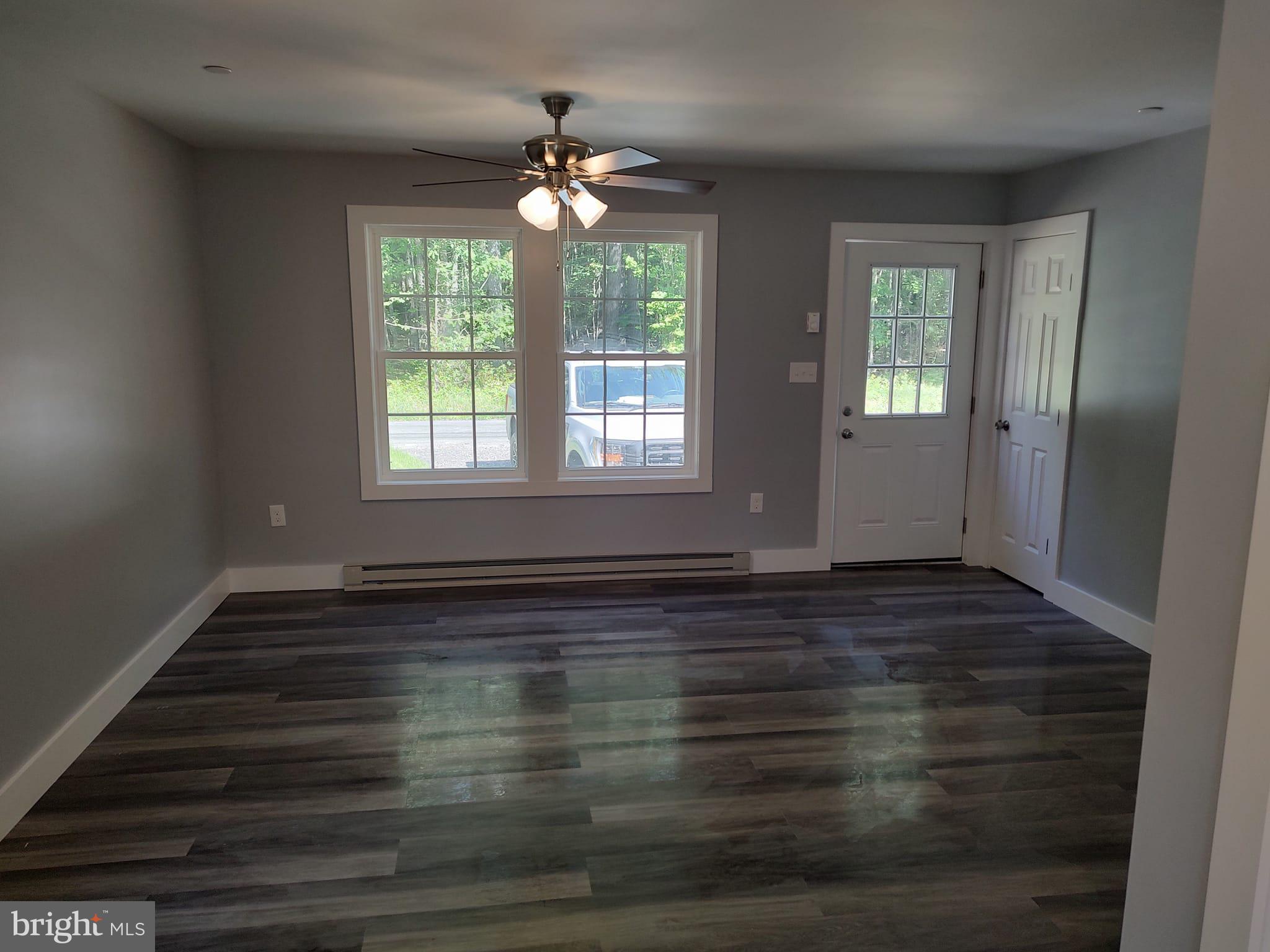 10103 Copperville Road Easton, MD 21601 - Photo 3 of 5 a view of an empty room with wooden floor and a window