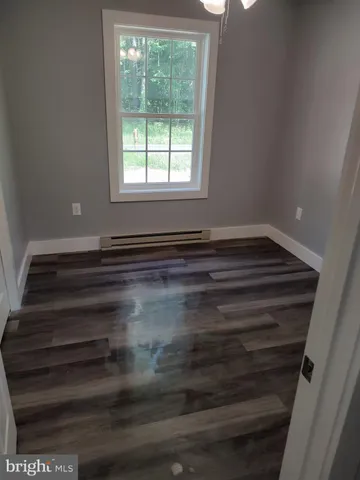a view of room with wooden floor and window