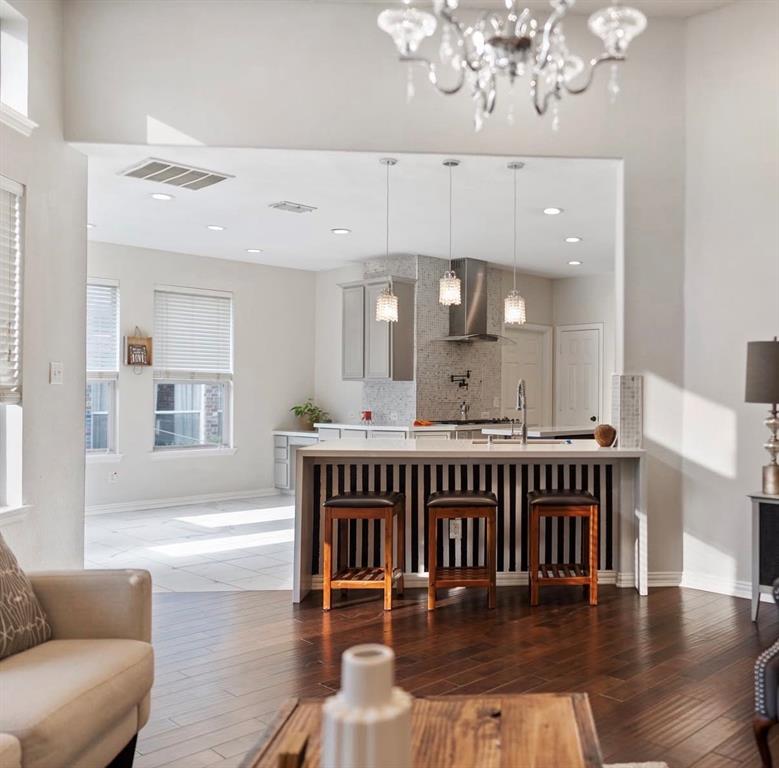 1424 Winston Drive McKinney, TX 75072 - Photo 2 of 28 a living room with furniture and a chandelier