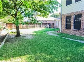 a view of backyard with outdoor seating and green space