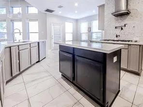 a kitchen with stainless steel appliances granite countertop a stove and a sink