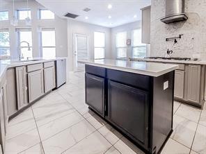 1424 Winston Drive McKinney, TX 75072 - Photo 3 of 28 a kitchen with stainless steel appliances granite countertop a stove and a sink