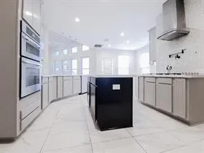 a kitchen with kitchen island a sink appliances and cabinets