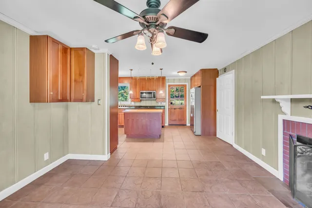 a open kitchen with stainless steel appliances granite countertop a refrigerator and a sink