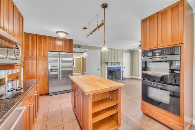a kitchen with refrigerator and cabinets