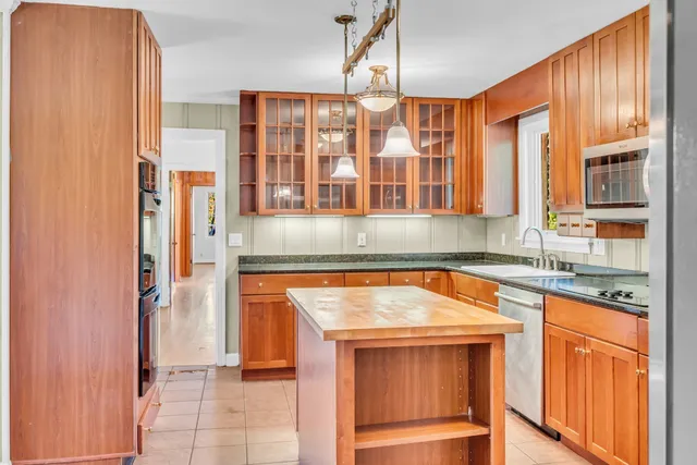 a kitchen with stainless steel appliances granite countertop a refrigerator and a sink
