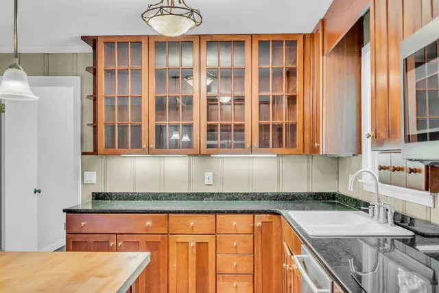 a kitchen with stainless steel appliances granite countertop a sink and a granite counter tops